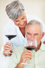 Mature couple, wine or glasses with alcohol for tasting, celebration or date together at home. Elderly, man and woman with liquid, drink or alcoholic beverage for romance, holiday or bonding at house