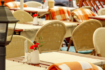 Prague, Czech Republic - May 11, 2019: Сhairs and tables in a cafe., closeup photo. The interior of a summer restaurant without people. Horizontal photo. Restaurant on the street without people.