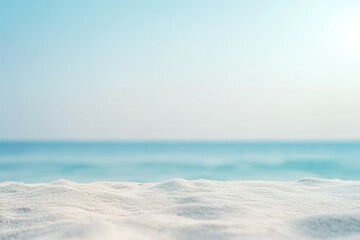 Fototapeta premium Soft light beach sand in the foreground and shimmering sea with sunrays in the background