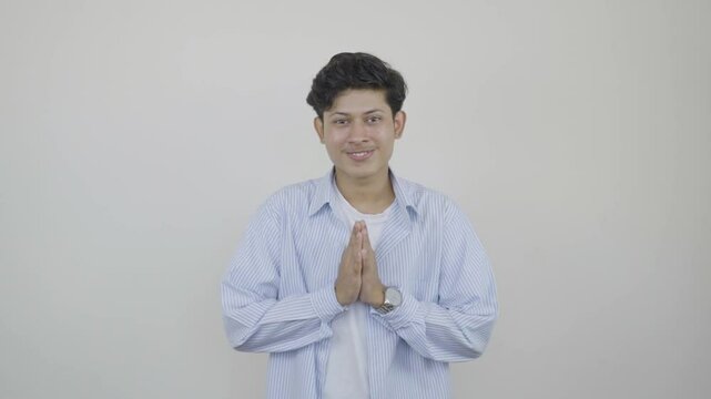 Young Asian Student gives gestures  of Namast