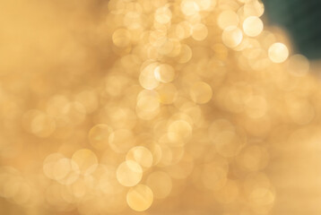 Abstract golden bokeh light background, perfect for festive, holiday, or celebratory themes in design and decoration.