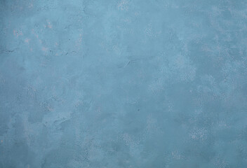 Close-up of a blue textured concrete wall, perfect for use as a background in design, art, or creative projects.