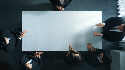 Top down aerial view of skilled business team clapping hands to celebrate young businesswoman...