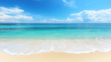 A panoramic view of a pristine white sandy beach with turquoise water and a blue sky with white clouds.