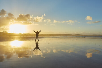 A man on the shores of the Atlantic Ocean enjoying the sunrise. Morocco