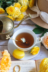 Cup of tea with orange and small pumpkins on white table, September.
