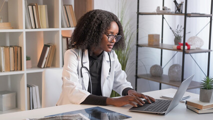 Diagnosis internet research. Study information. Thoughtful doctor woman in medical uniform sitting...