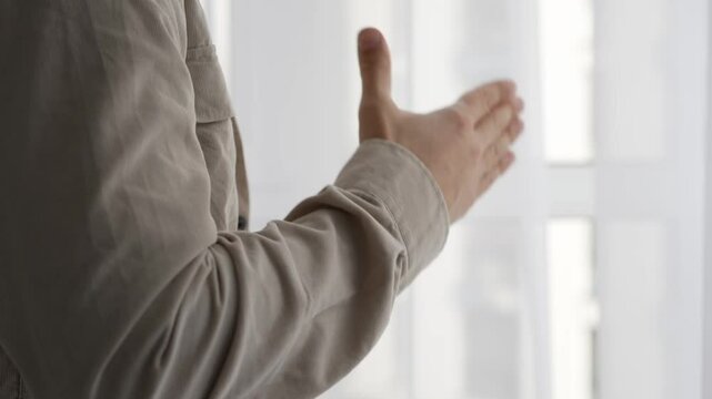 A young guy in a light shirt extends his hand to say hello.
Gesture of greeting.
A man extends his hand to his interlocutor to shake his hand.