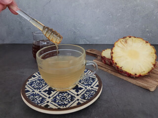 Cup of pineapple tea made with the fruit or the peel, zero food waste.
