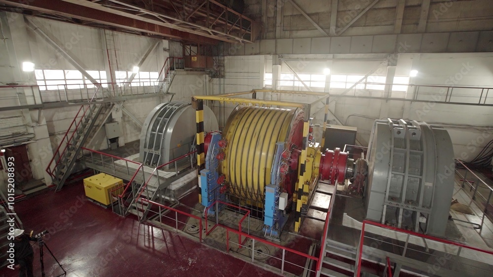 Poster industrial machinery functioning and operating effectively inside a large factory. stock clip