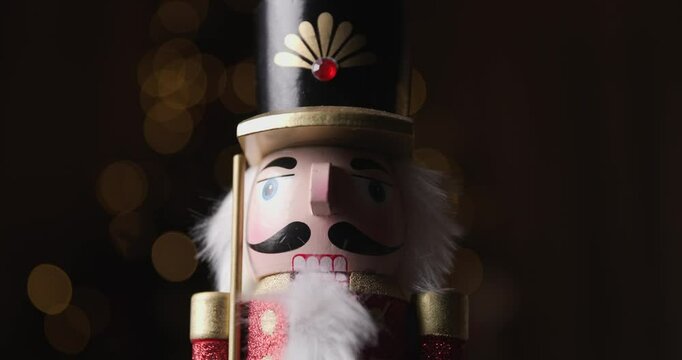 the Nutcracker from Tchaikovsky's well known ballet being representative for Christmas, spinning with bokeh lights behind