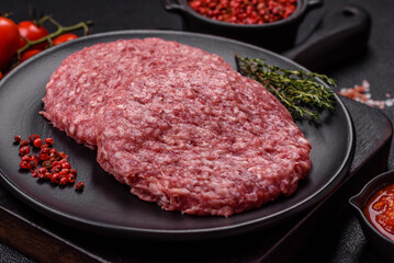 Fresh raw ground beef burger patty with salt and spices