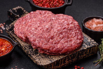 Fresh raw ground beef burger patty with salt and spices