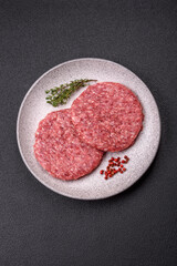 Fresh raw ground beef burger patty with salt and spices