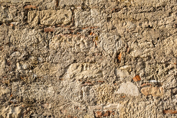 Old stone wall background, close-up. Stoney texture for publication, design, poster, calendar, post, screensaver, wallpaper, postcard, banner, cover, website. High quality photo