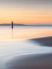 Fototapeta premium Minimalist Sunset with a Solitary Lighthouse and Calm Waters Reflecting the Sky
