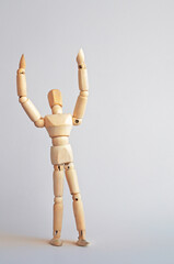  A wooden figure in the form of a man stretches out his arms to the sky