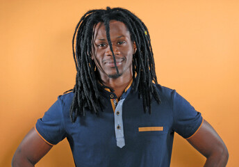 African curly hair man portrait on orange background.
