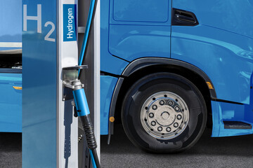 A hydrogen fuel cell semi truck with H2 gas cylinder onboard next to filling station. Eco-friendly...