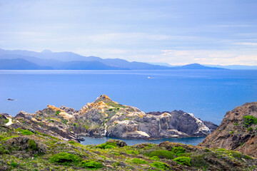 Cap de Creus: Rocky landscape and famous hiking trail Cami de Ronda on the Mediterranean Sea with a view towards the french coast, border of Spain and France near Cadaqués, Girona, Pyrenees, Catalonia