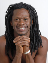 Happy African native curly hair man with hands on face portrait. 