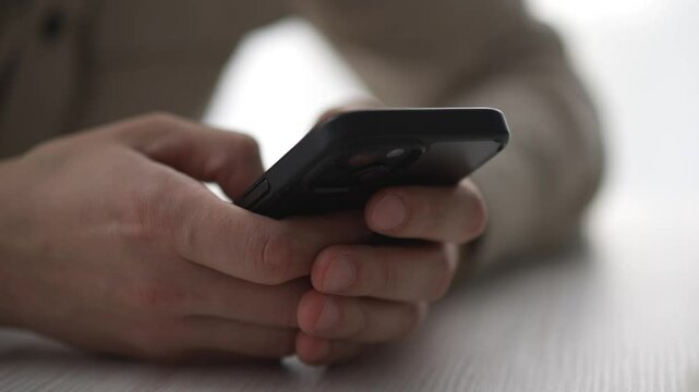 the phone is in the guy's hands.
A man uses a gadget.
Paner types a message on his smartphone.
Work, technology, smart, IT specialist, sms, screen
