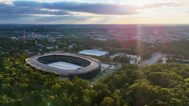 Kaunas Darius and Girenas football stadium, largest in Lithuania. Aerial 4K drone video footage of a multi-use stadium in Azuolynas oak park during a sunset