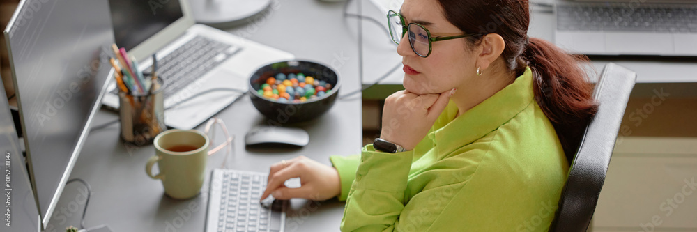 Poster website header shot of young red haired female software engineer wearing green shirt and glasses foc