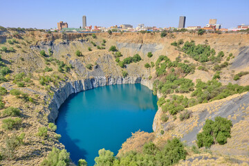 Big hole in Kimberley and city at the background ancient diamond mine in Kimberley, South Africa