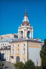 Fototapeta premium The belfry of the Znamensky Monastery in the center of Moscow on a clear sunny day, the Sights of Russia. Architecture of World tourism.