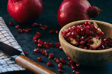 red ripe pomegranate fruits on dark background