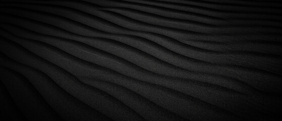Black Sand dune. Black Sand beach macro photography. Background, texture, wave pattern of oceanic sand on the beach, black. Texture of beach sand. Black beach.