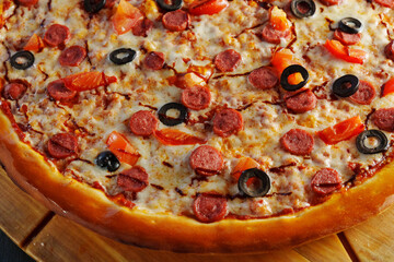 Freshly baked pepperoni pizza, generously layered with olives and tomatoes, emerges golden and crispy, inviting everyone to indulge in a delightful culinary experience.