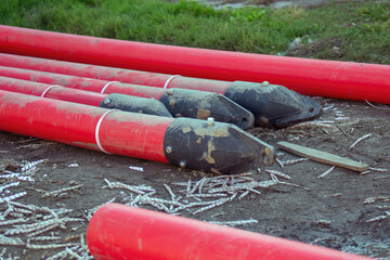 striking image showcasing large red pipes with black plastic ends, designed for transport. The...
