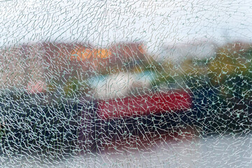 A shattered glass texture beautifully blurs the vibrant colors of the garden beyond, capturing a...