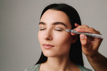 Blepharoplasty markup close-up on the face before the plastic surgery operation for modifying the...