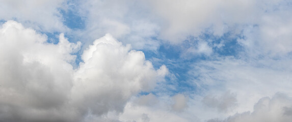 white curly clouds in the blue sky