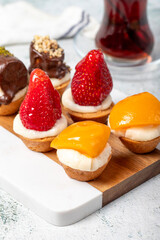 Fruit tartlet dessert on gray background
