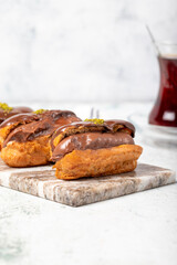 Chocolate eclair dessert on gray background