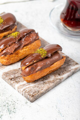 Chocolate eclair dessert on gray background