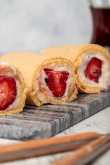 Strawberry roll dessert on gray background