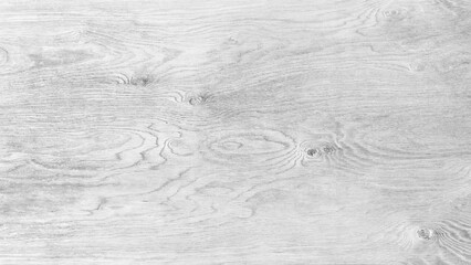 A wooden surface with a grainy texture. The wood is white and has a natural look. The surface is smooth and has a slight shine to it