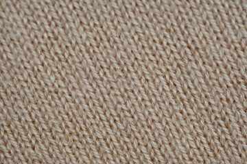 texture of knitted light brown sweater, close-up texture of beige knitted fabric, macro texture of tan knitted woolen clothes
