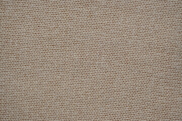  texture of knitted light brown sweater, close-up texture of beige knitted fabric, macro texture of tan knitted woolen clothes