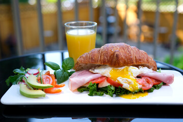 french breakfast croissant with balyk tomato cheese and salad orange juice and salad. Italian Lunch