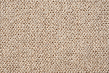  texture of knitted light brown sweater, close-up texture of beige knitted fabric, macro texture of tan knitted woolen clothes