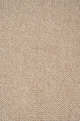  texture of knitted light brown sweater, close-up texture of beige knitted fabric, macro texture of tan knitted woolen clothes