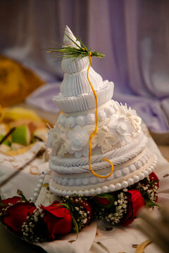 A topor is a type of conical headgear, made of white sholapith, traditionally worn by grooms as part of the Bengali Hindu wedding ceremony. Bengali wedding rituals, puja arrangement background