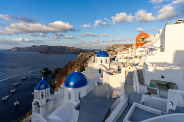Sunrise above Beautiful Oia town on Santorini island, Greece. Scenic Caldera travel background....