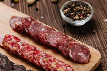 Close-up of sliced salami with nuts, gourmet meat textures and flavors, charcuterie boards